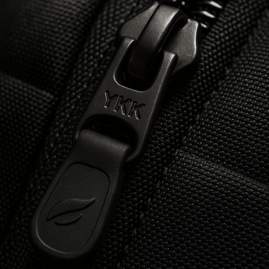 A close-up macro shot of a high-quality YKK zipper on a backpack